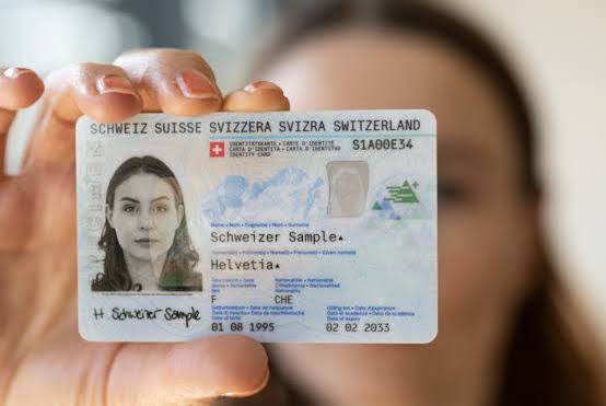 Carte d'identité suisse tenue en main